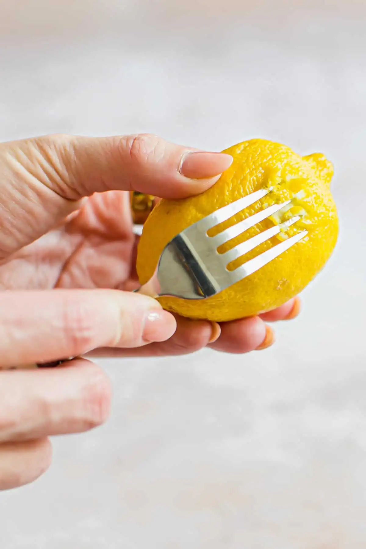 Zesting a lemon using a fork.