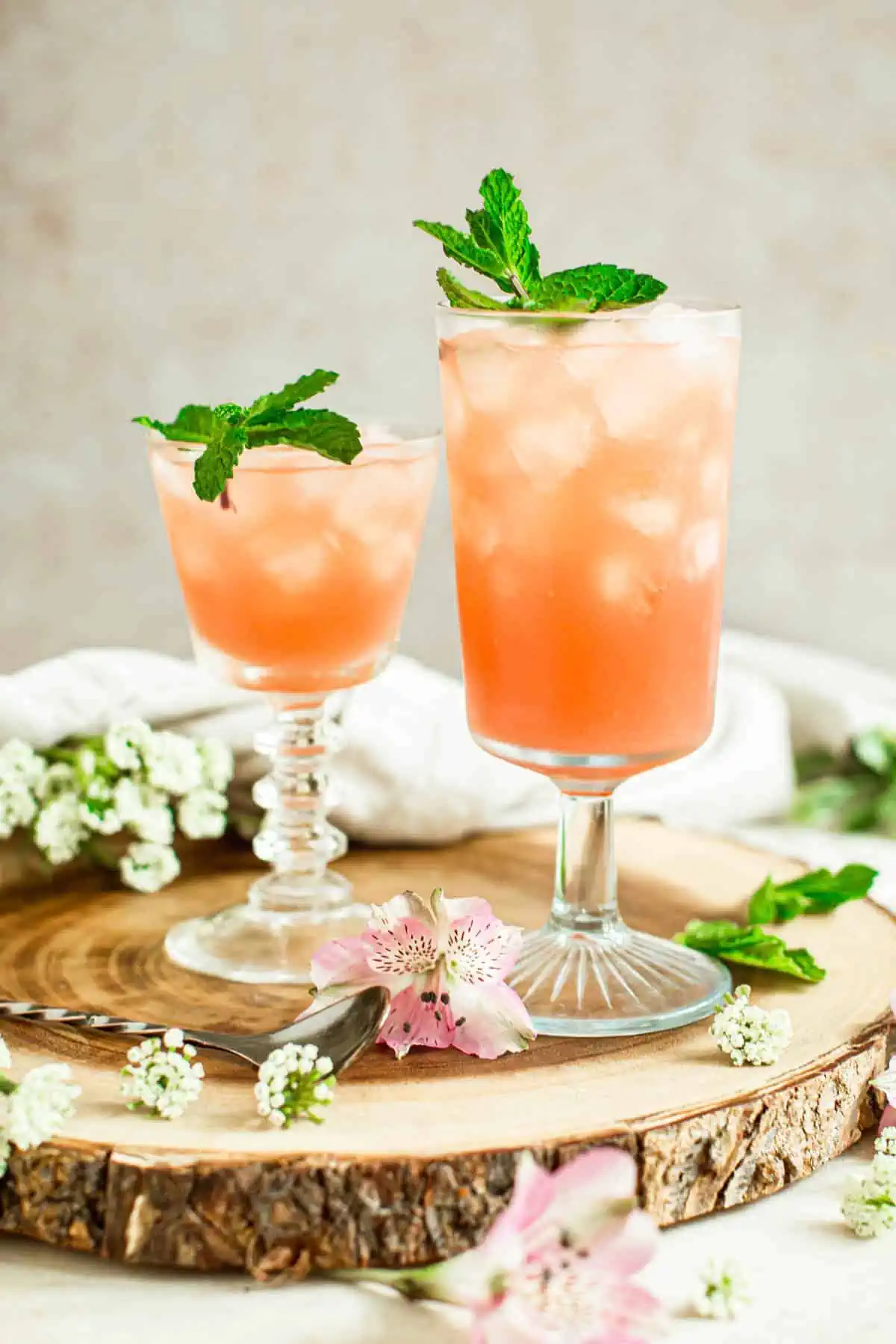 Azalea drink in two glasses garnished with fresh mint.