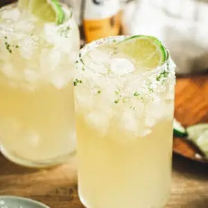 Beer margarita with a salted rim and lime wedge.