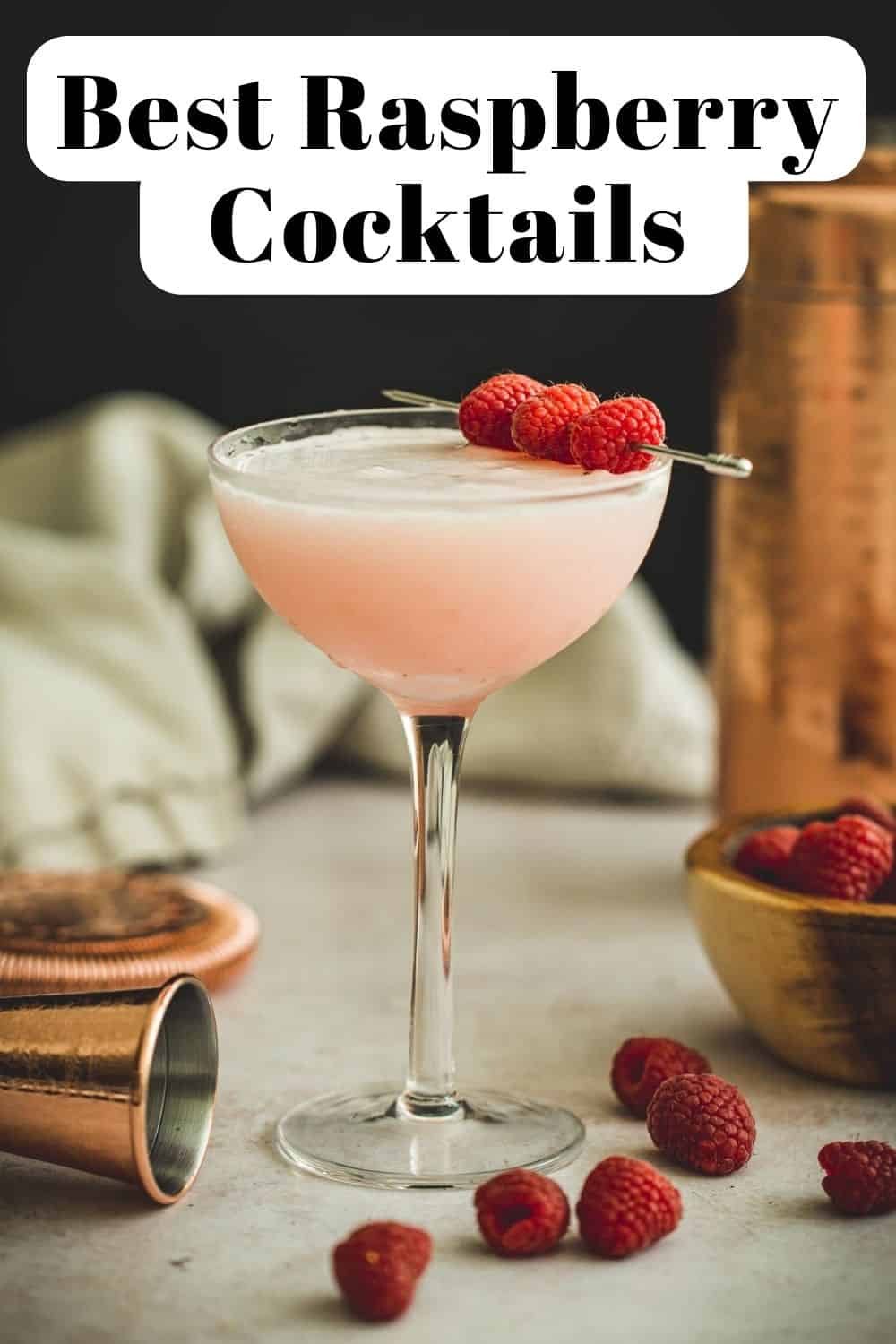 Clover club cocktail in a coupe glass with fresh raspberries.