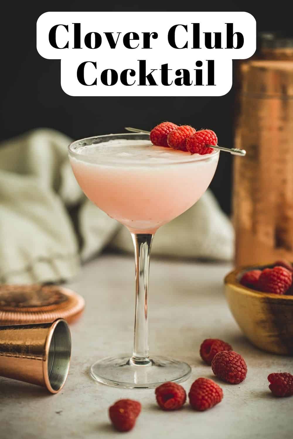 Clover club cocktail in a coupe glass.