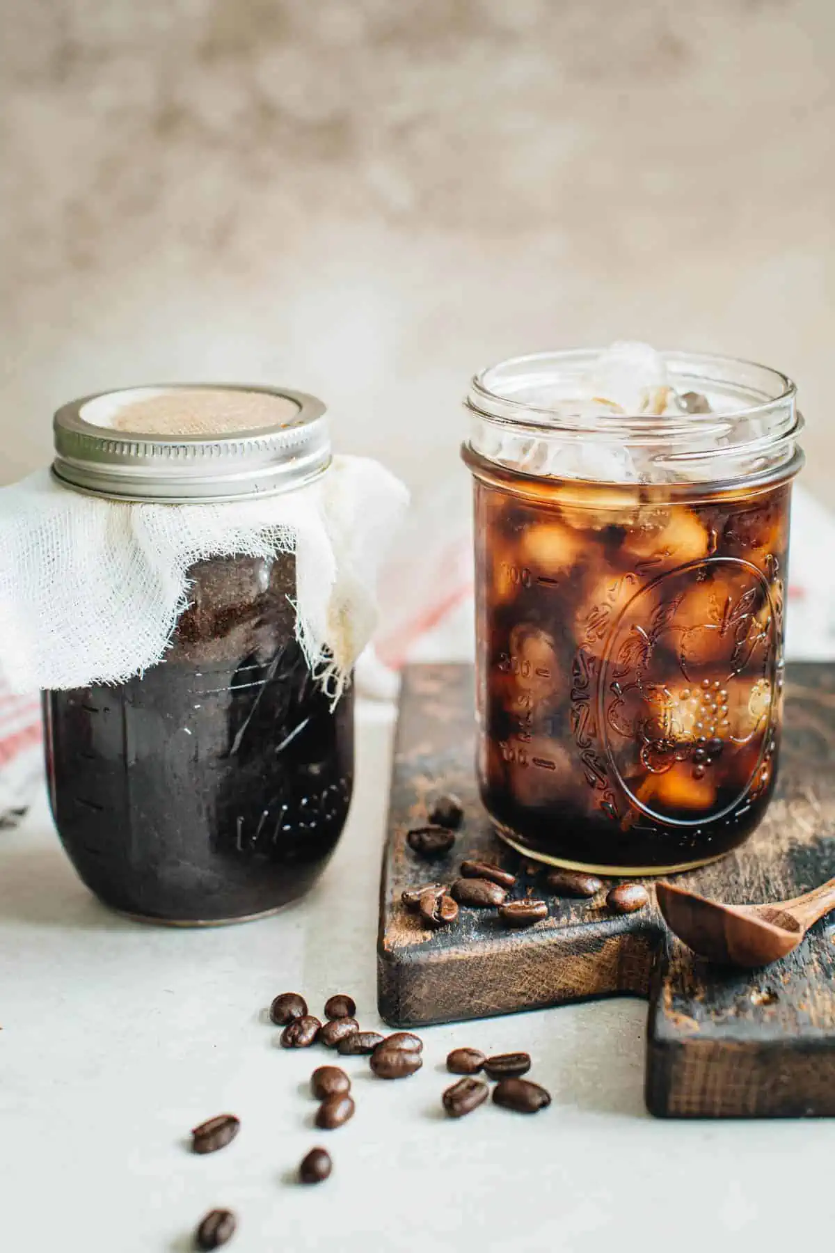 Cold brew in a mason jar and in a glass filled with ice.