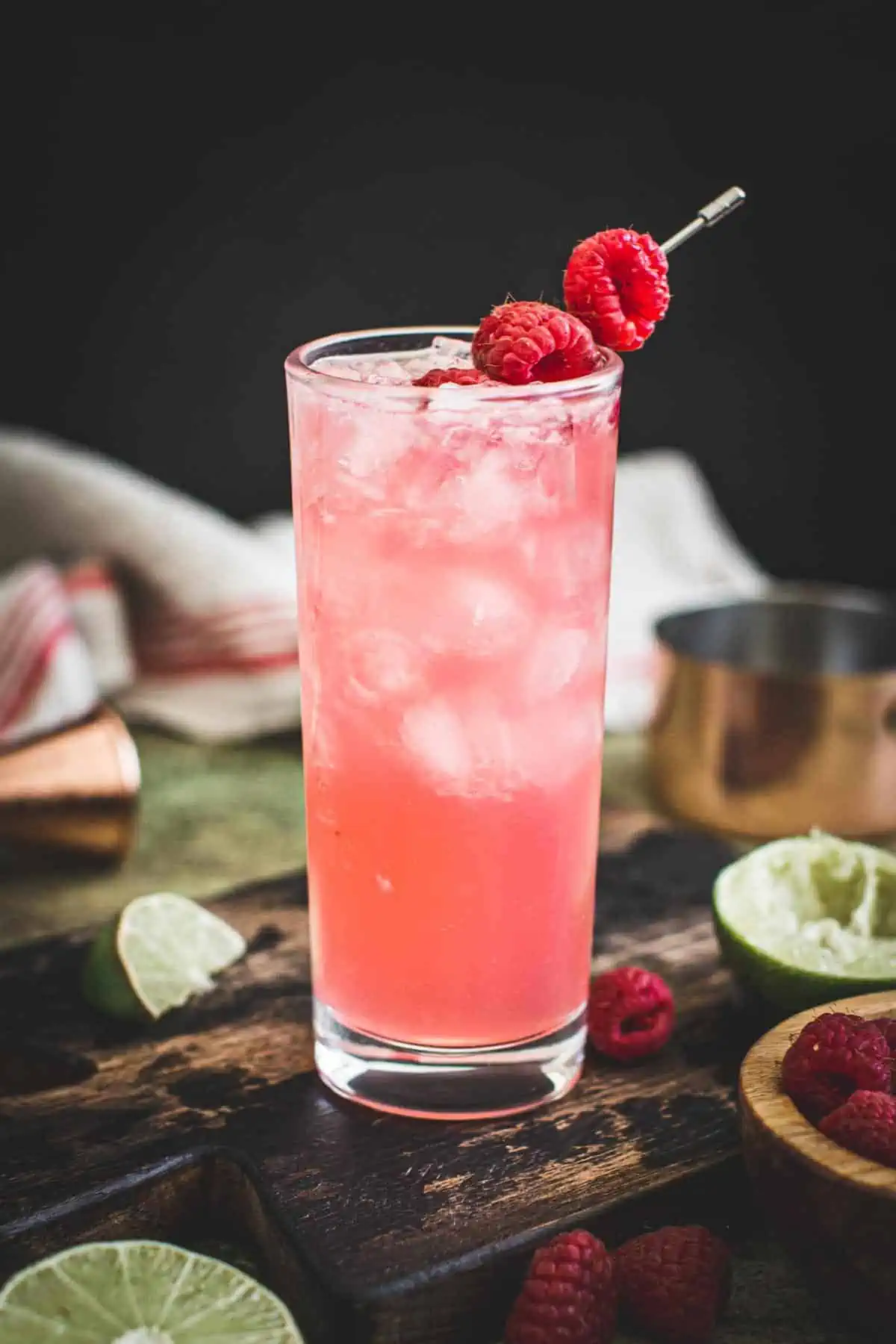 Floradora cocktail with fresh raspberries for garnish.