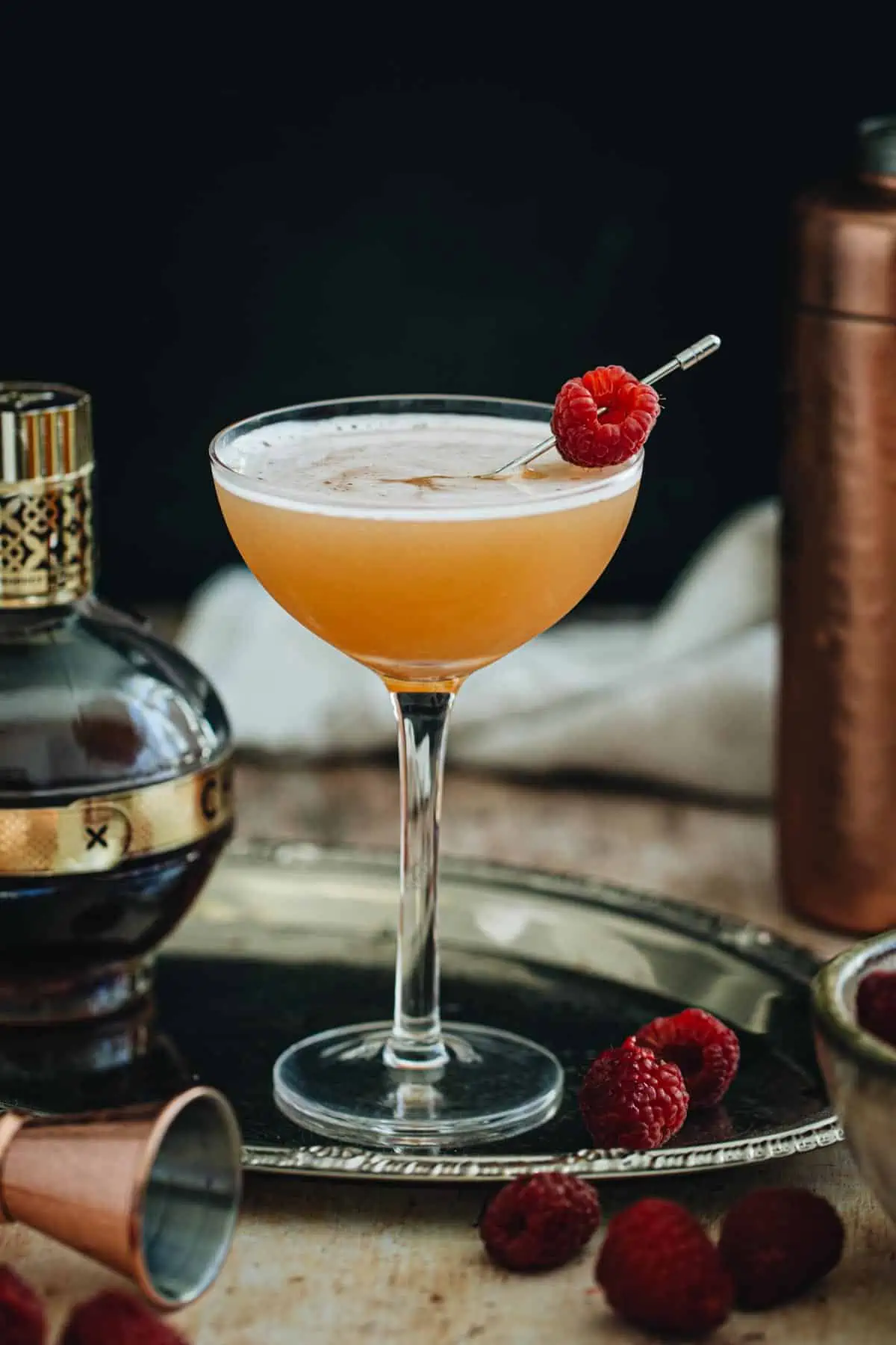 French martini in a coupe glass with a fresh raspberry for garnish.