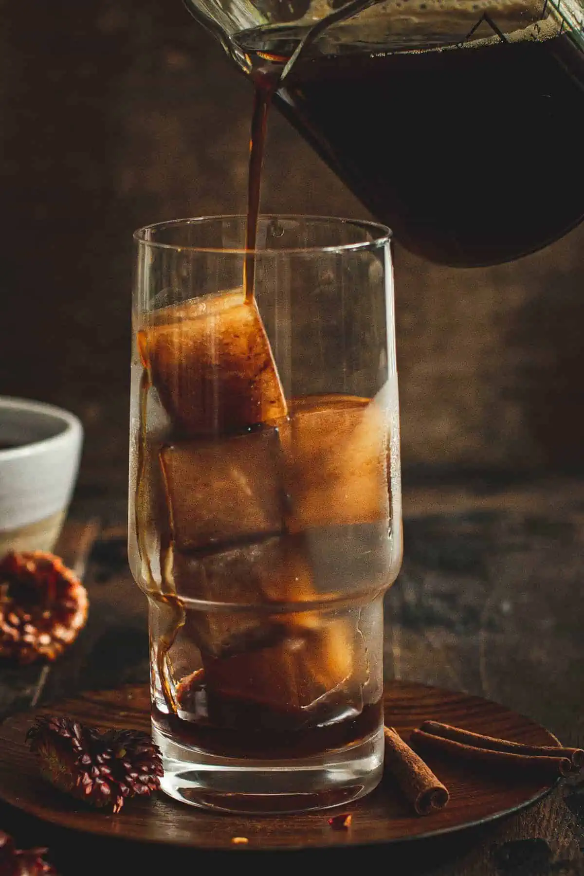 Coffee pouring over coffee ice cubes.