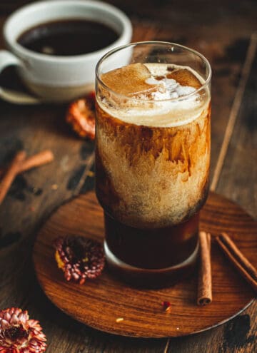 Iced hazelnut coffee in a glass with cream.