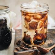 Mason jar cold brew over ice with cream.