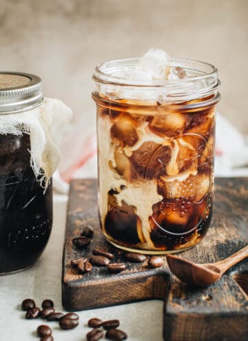 Mason jar cold brew over ice with cream.