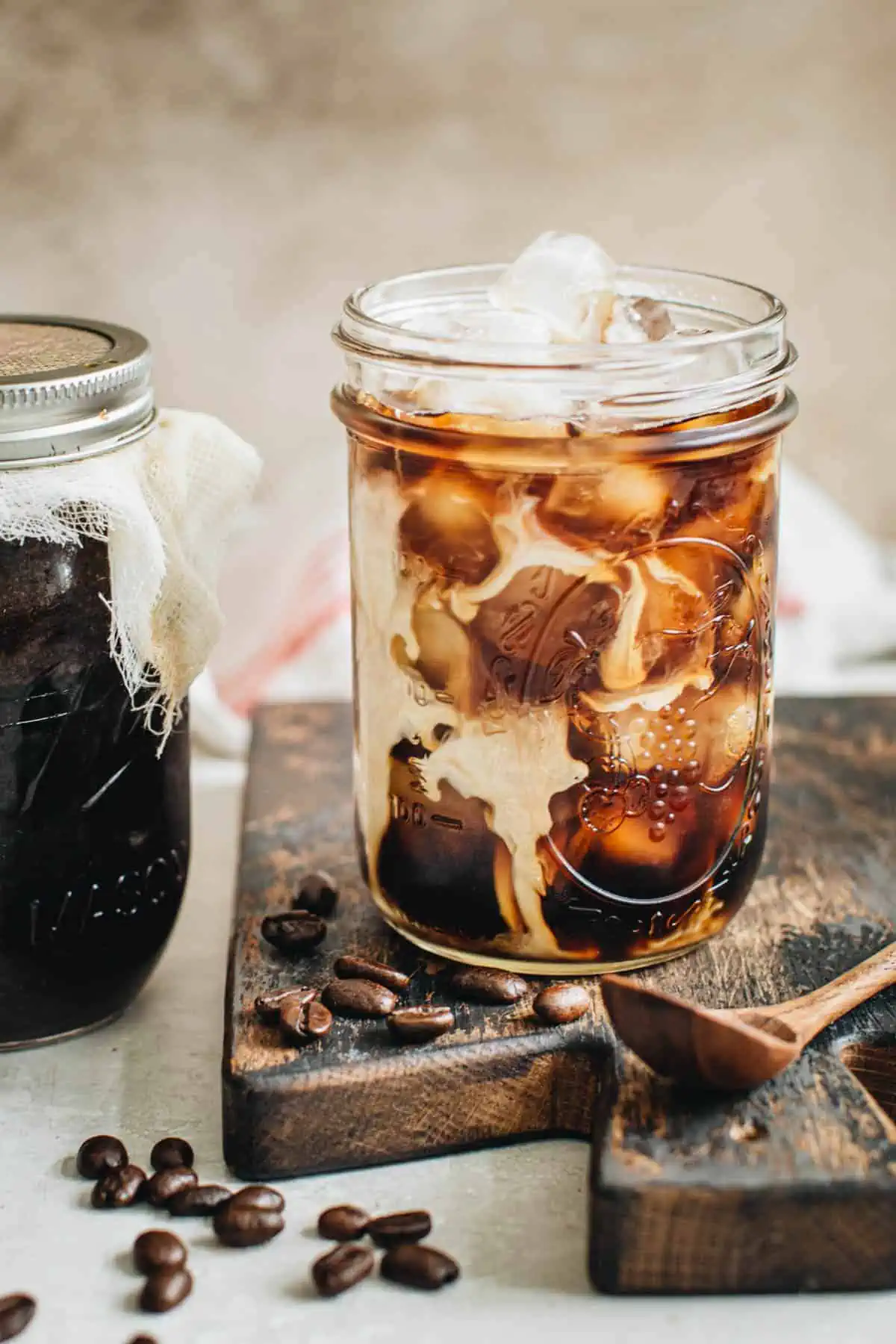 Mason jar cold brew over ice with cream.