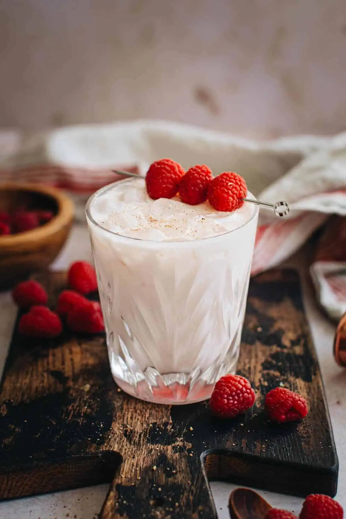 Nuts and berries drink garnished with raspberries.