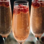 Raspberry champagne in flutes.