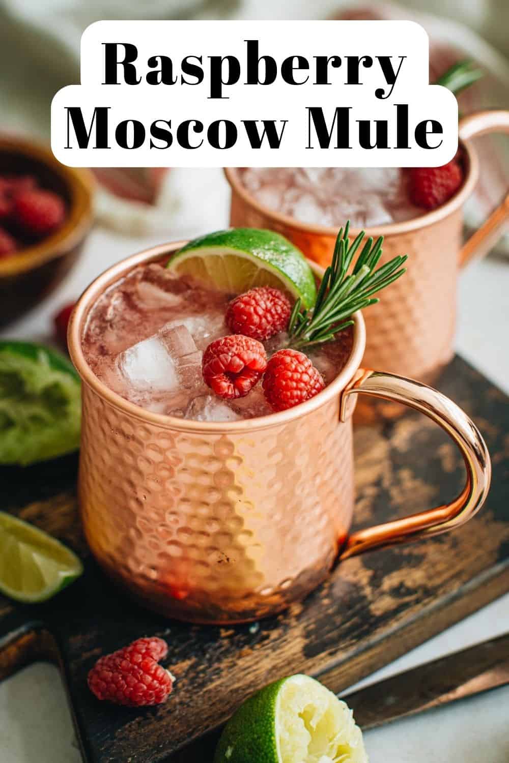 Raspberry mule in a copper mug with fresh strawberries for a garnish.