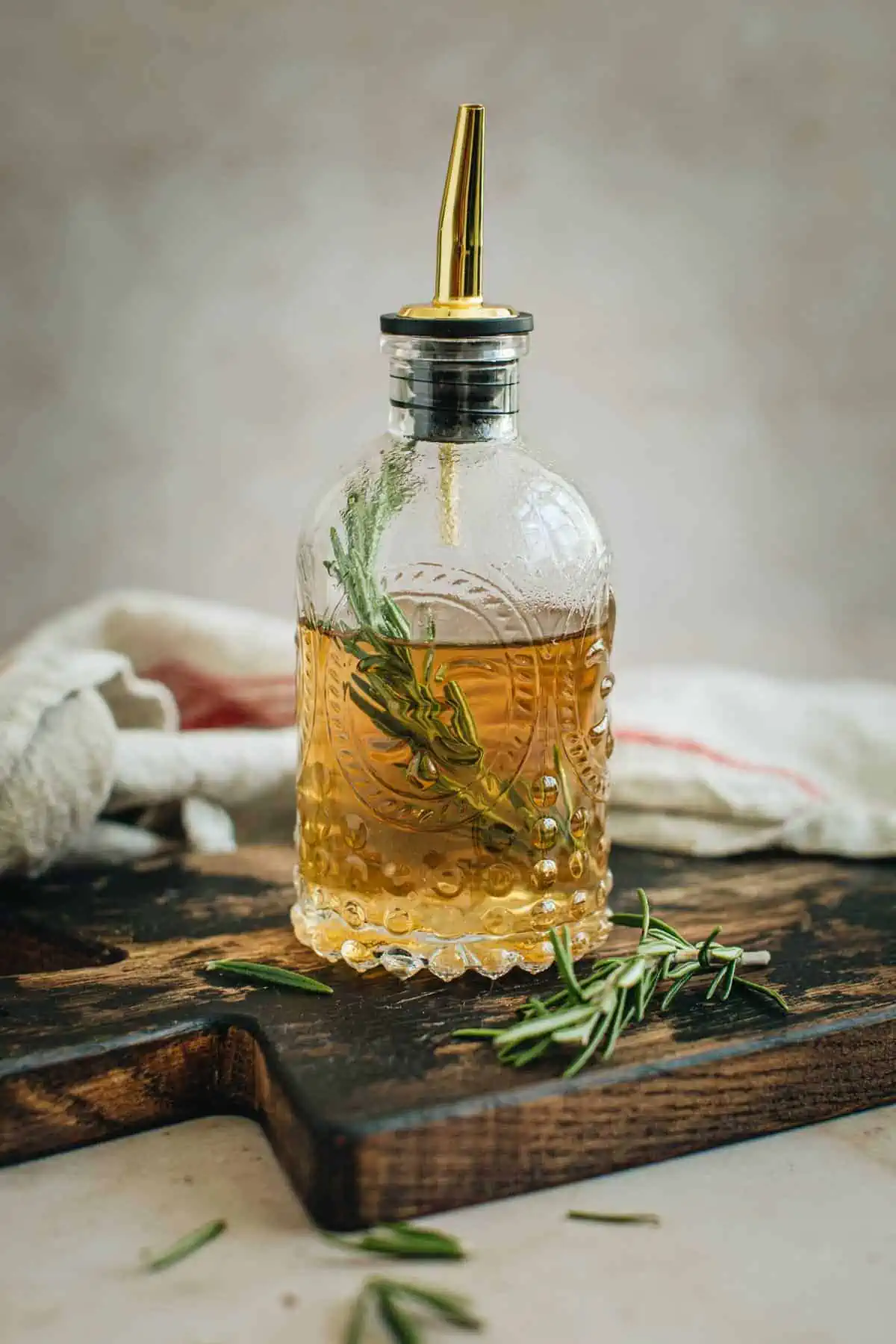 Bottle filled with rosemary simple syrup.