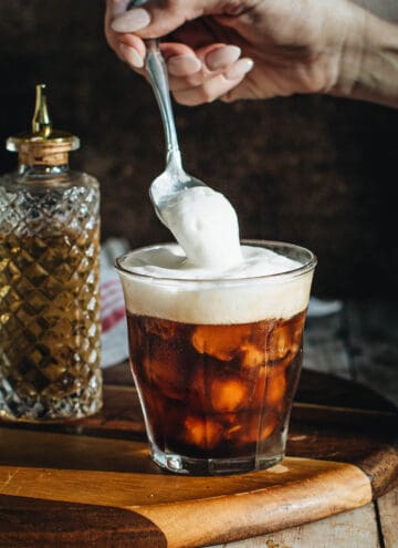 Spoon cold foam on top of iced coffee.