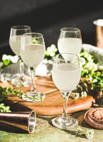 White tea shots in shot glasses with stems.