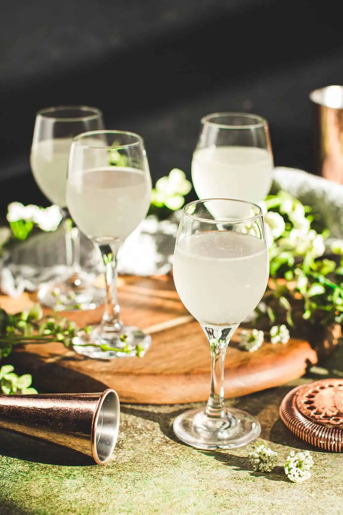 White tea shots in shot glasses with stems.