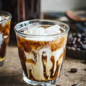 Iced coffee in a glass with cream.