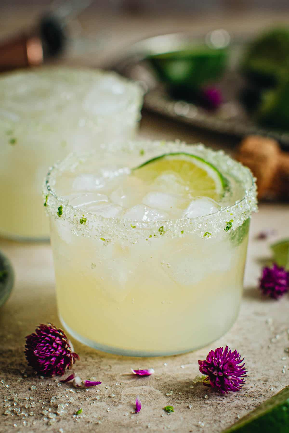 Champagned margarita with a sugared rim and lime wedge for garnish.