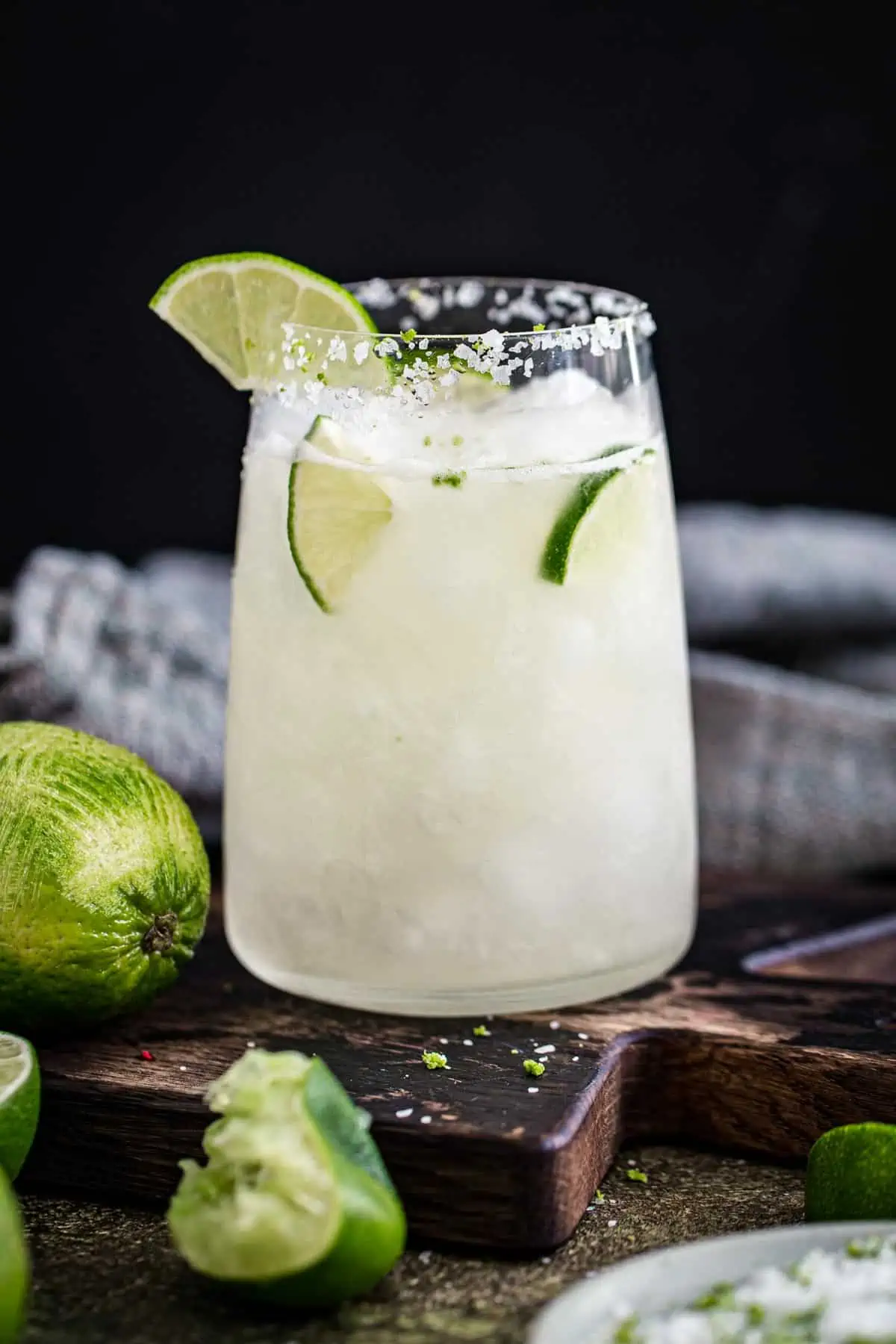 Vodka margarita with lime wedges for garnish.