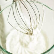 Whipped cream in an electric mixer.
