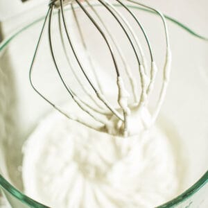 Whipped cream in an electric mixer.