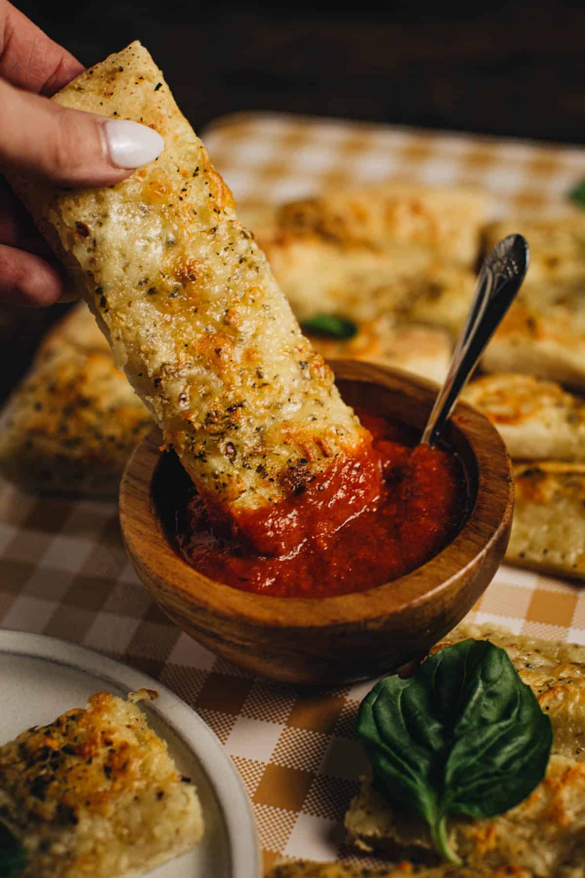 Easy pizza dipper dipping into marinara sauce.