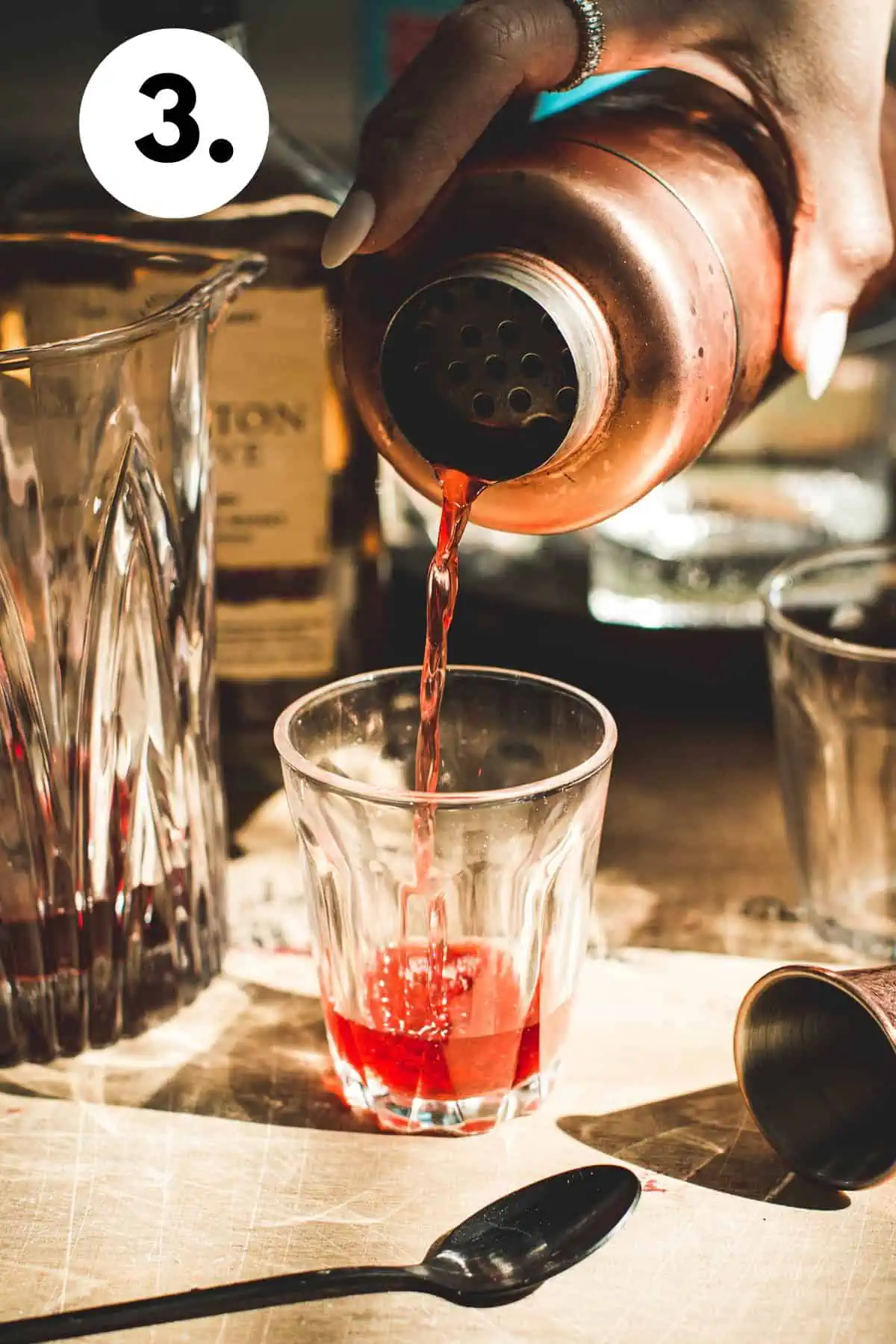 Pouring a shot into a shot glass.