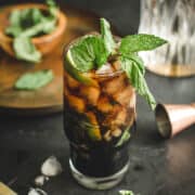 Mojito with black rum topped with fresh mint.