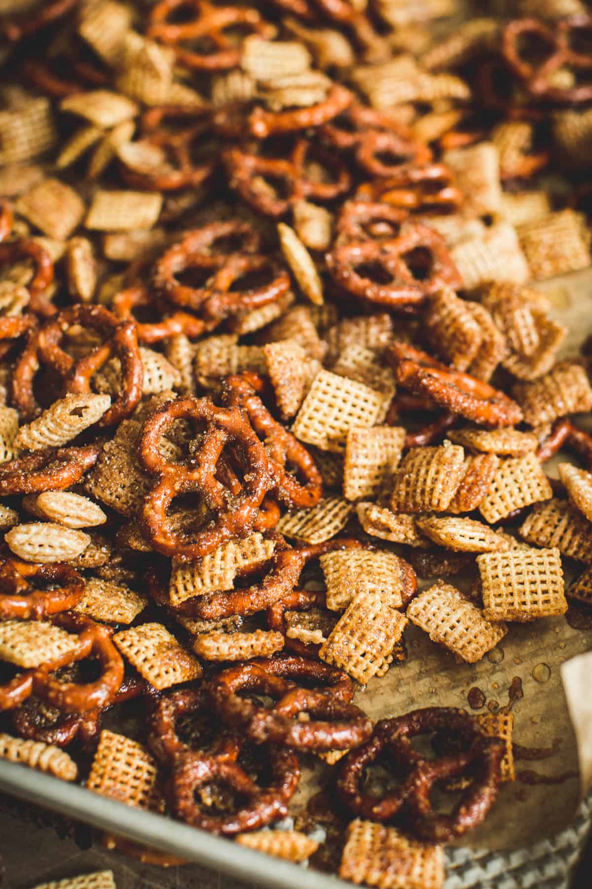 Cinnamon churros chex mix on a baking sheet.