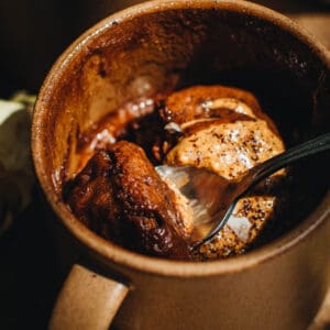 Nutella mug cake with a spoon.