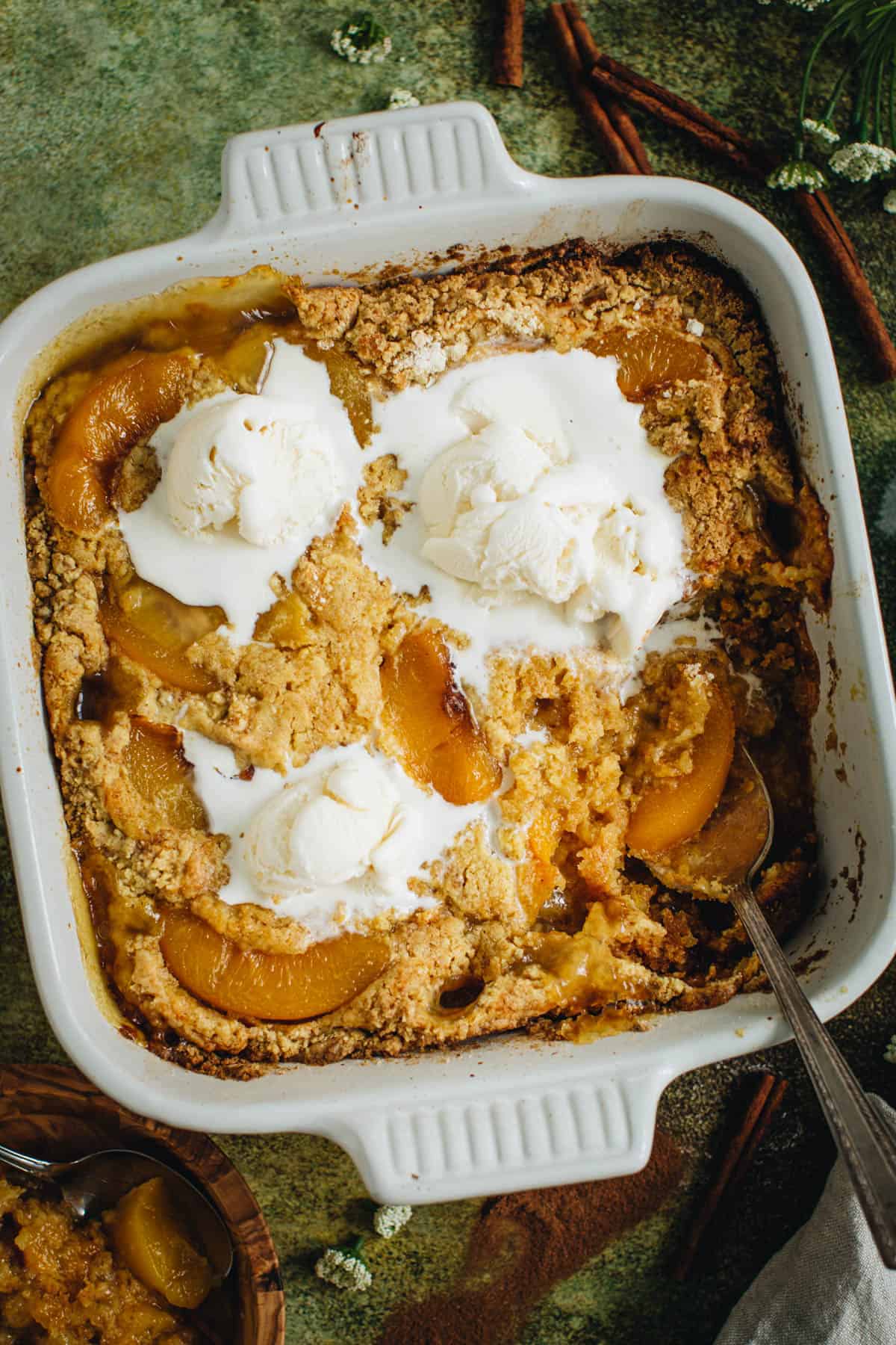 Pour the cake batter mix over the peach pie mix into the baking dish.