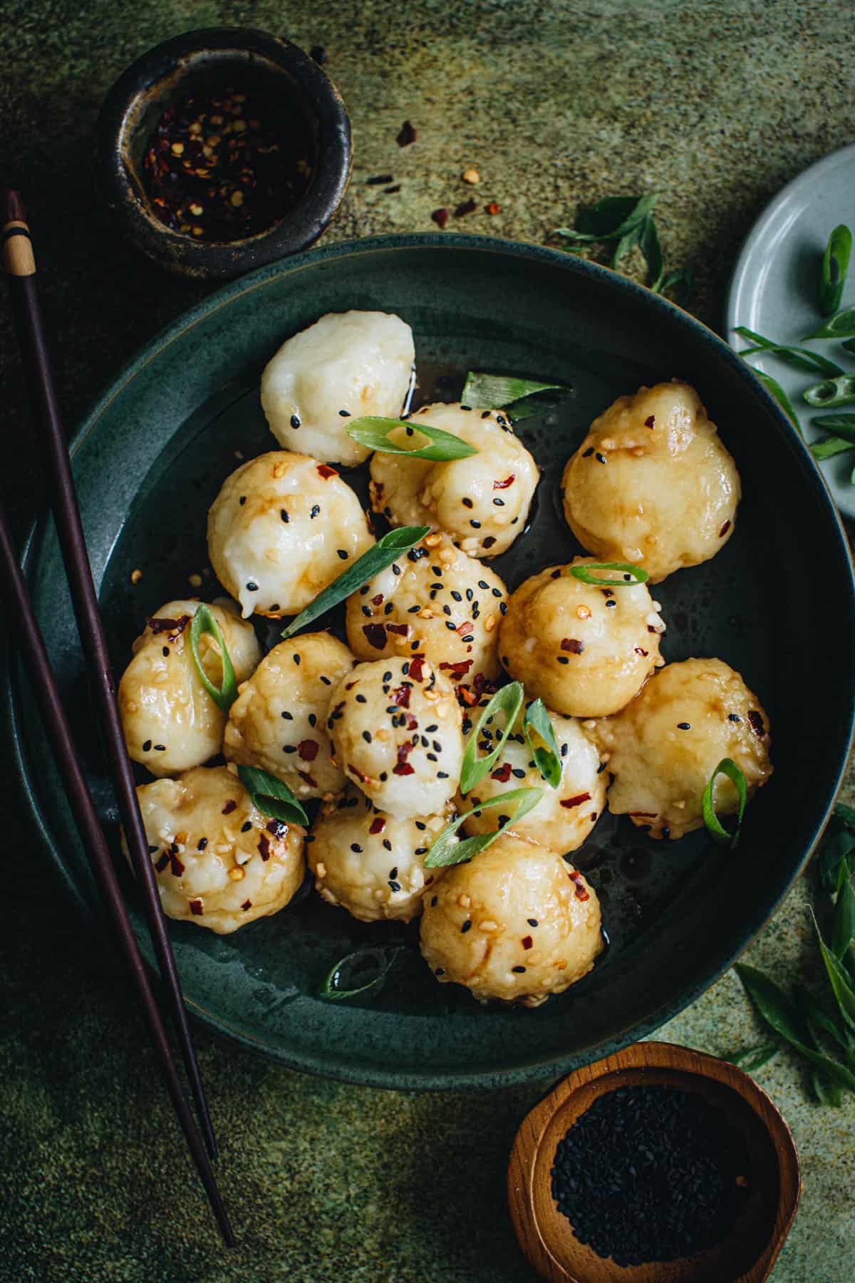 Potato dumplings in a bowl with chopsticks.