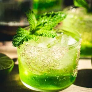 Caribbean Water cocktail with a mint garnish.
