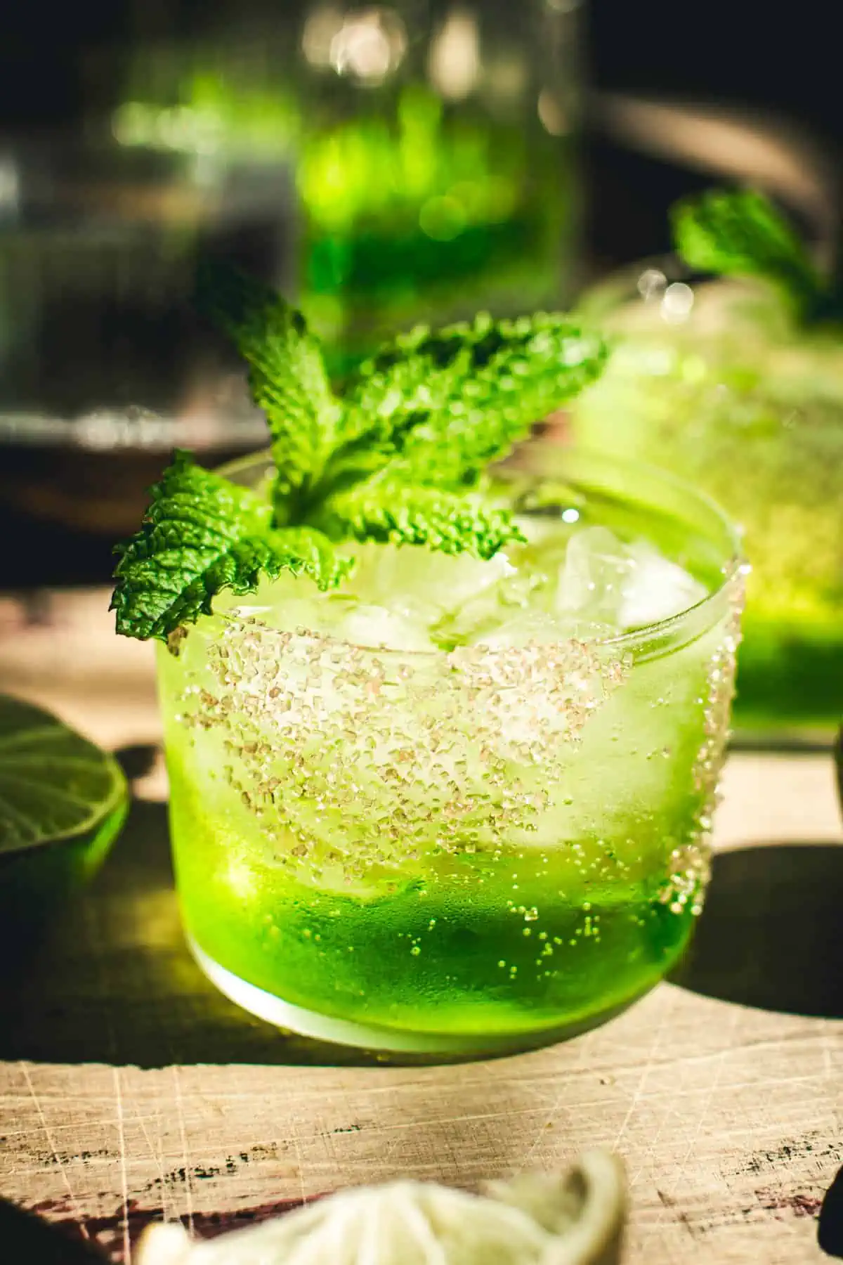 Caribbean water drink with a sugared rim and mint garnish.