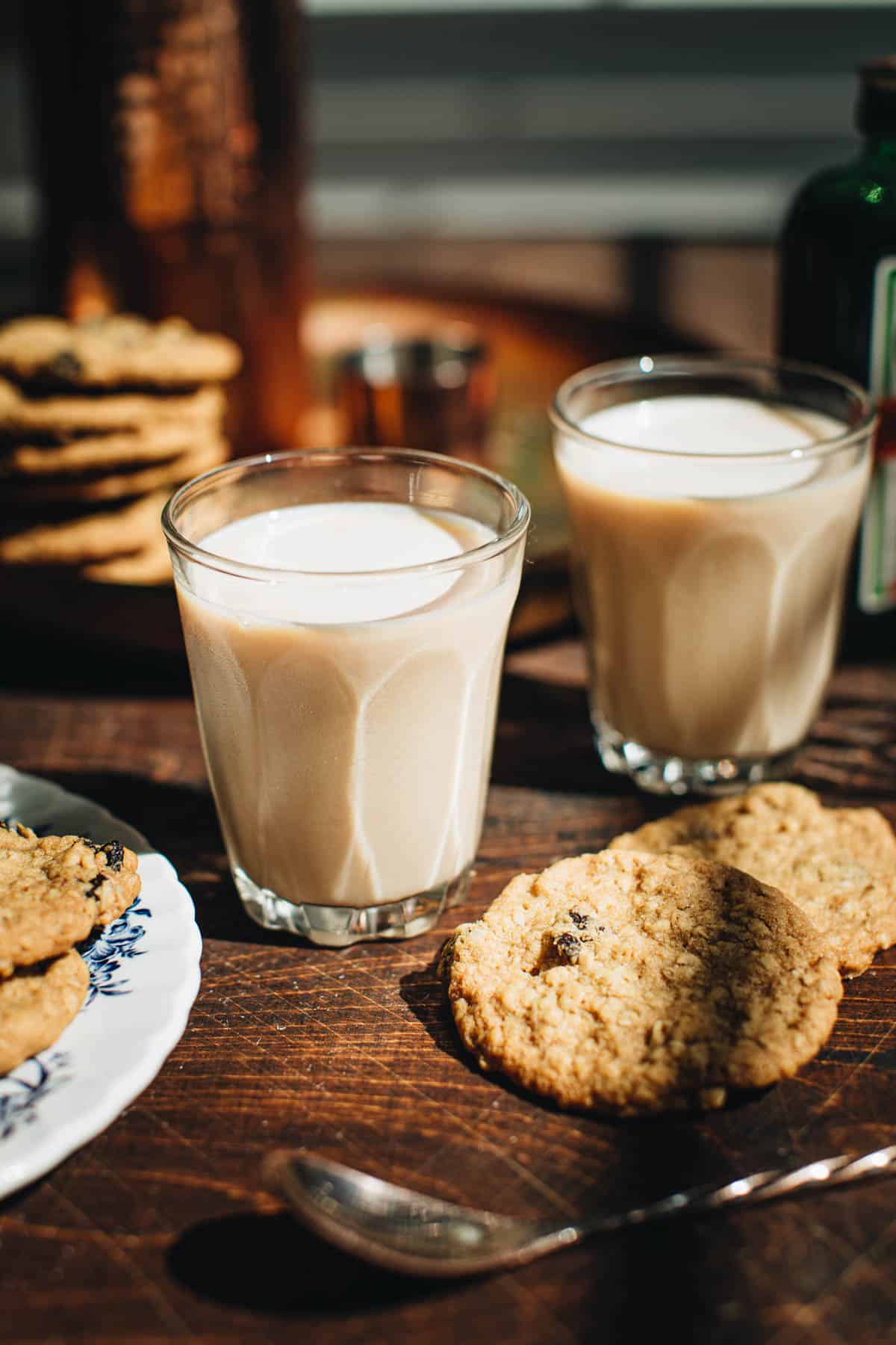 Oatmeal cookie shot in a shot glass sitting next to oatmeal cookies.