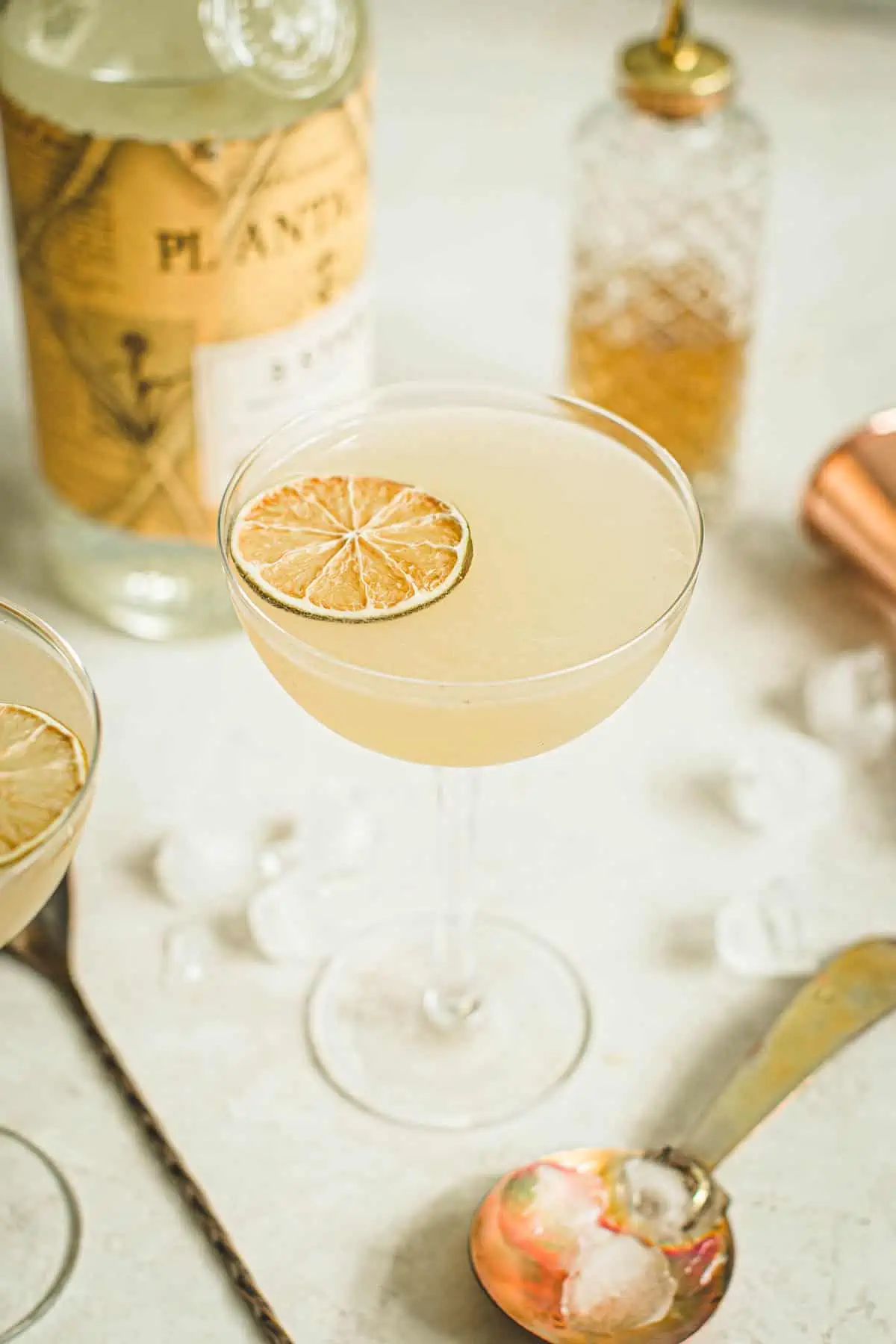 Classic daiquiri in a cocktial glass with a dehydrated lime wheel.