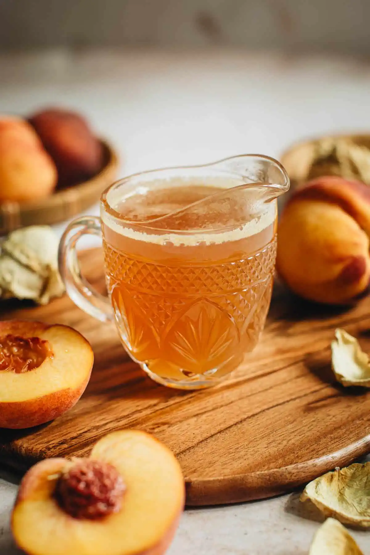 Peach syrup in a glass cup.