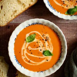 Spicy tomato soup in blue and white bowls.