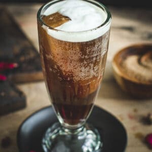 Coffee soda topped with cold foam.