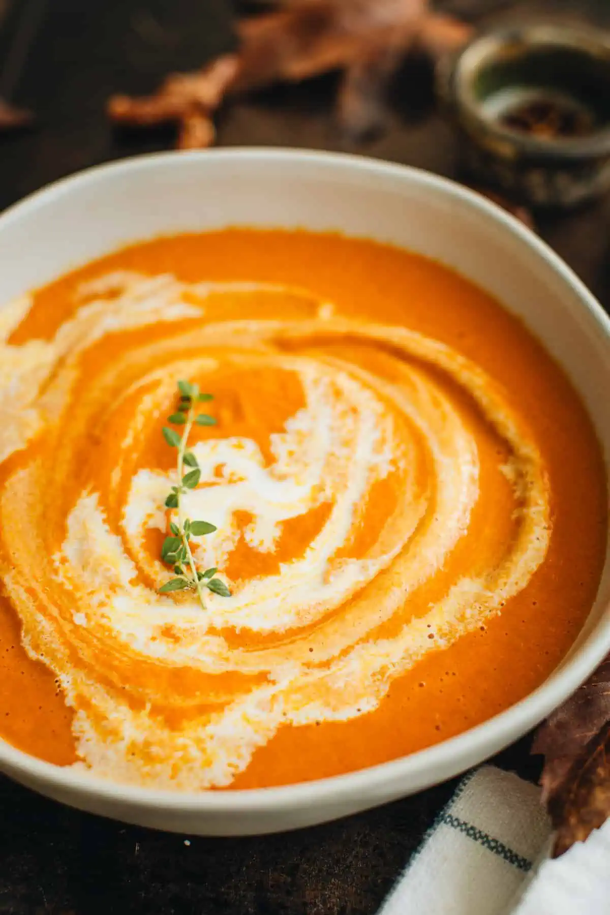 Creamy pumpkin tomato soup in a bowl.