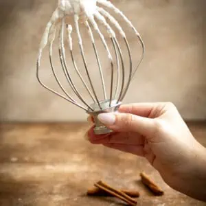 Cinnamon whipped cream on a whisk.