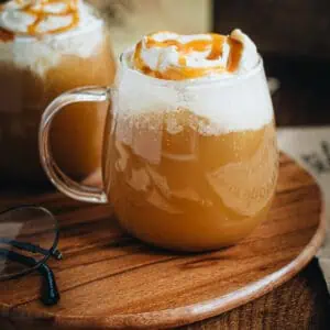 Hot butterbeer in a glass mug.