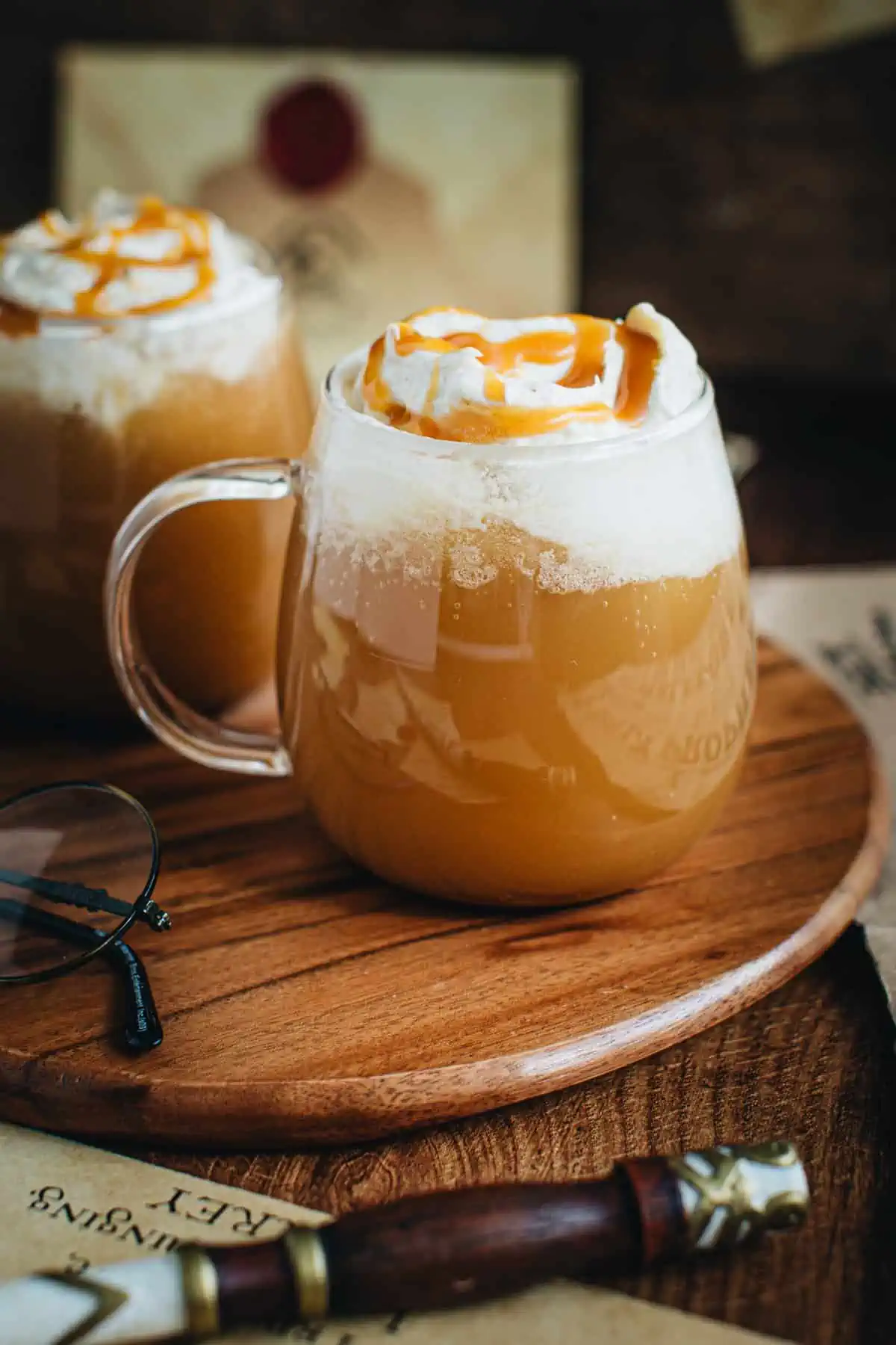 Harry Potter hot butterbeer in a glass mug.