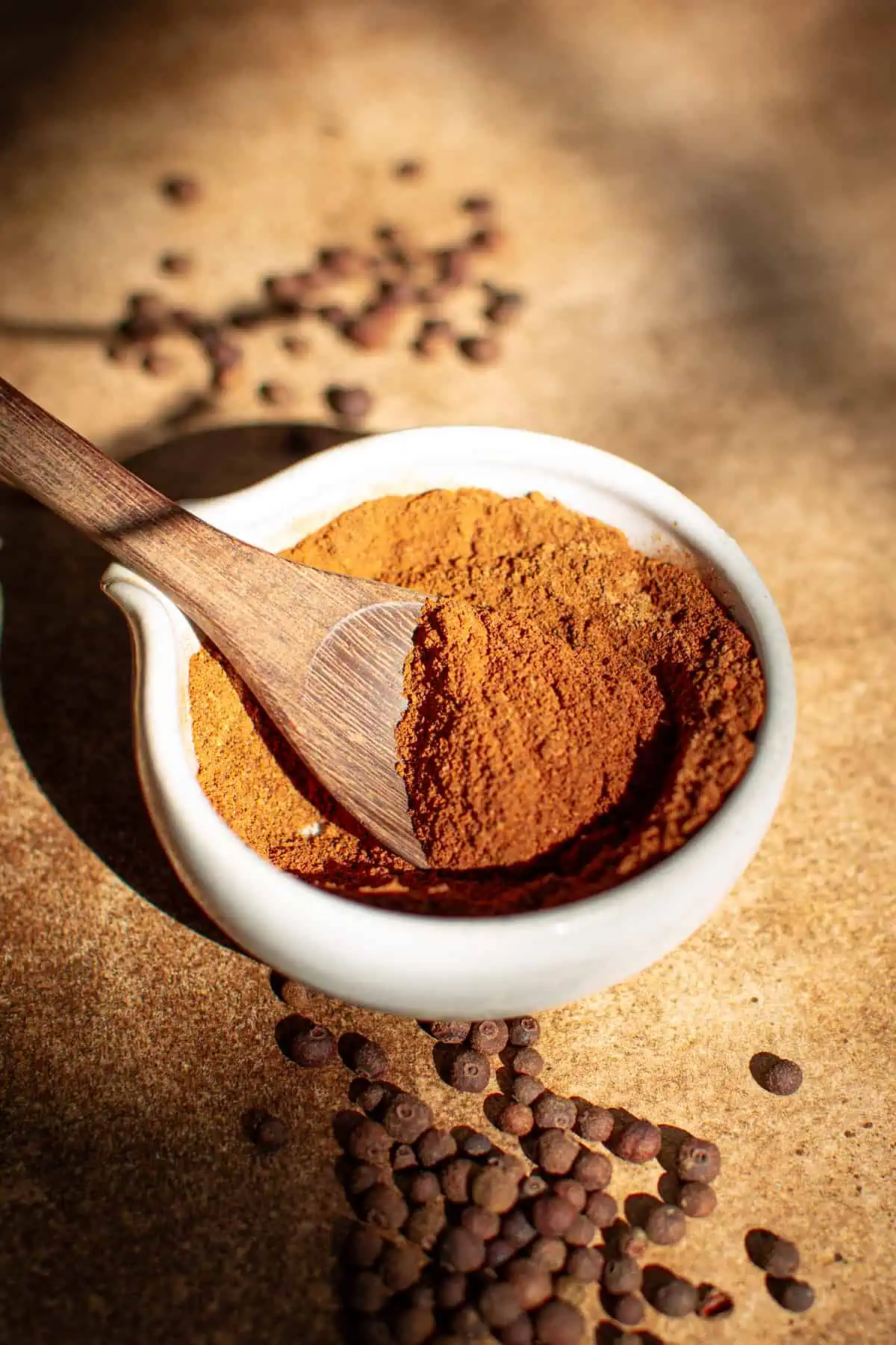 Homemade allspice recipe in a bowl with a spoon.