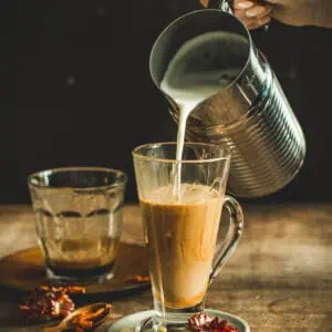 Pouring frothed milk into a latte.