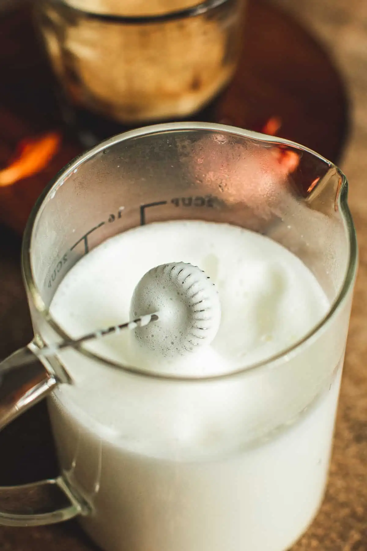 Frothing milk with a milk frother.