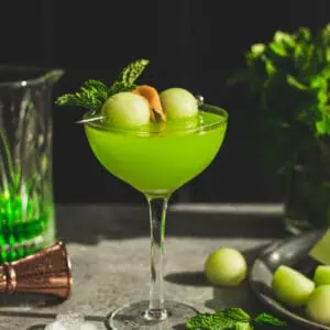 Melon ball drink in a coupe glass.