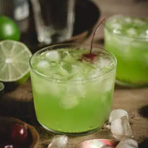 Midori Sour cocktail with a cherry.