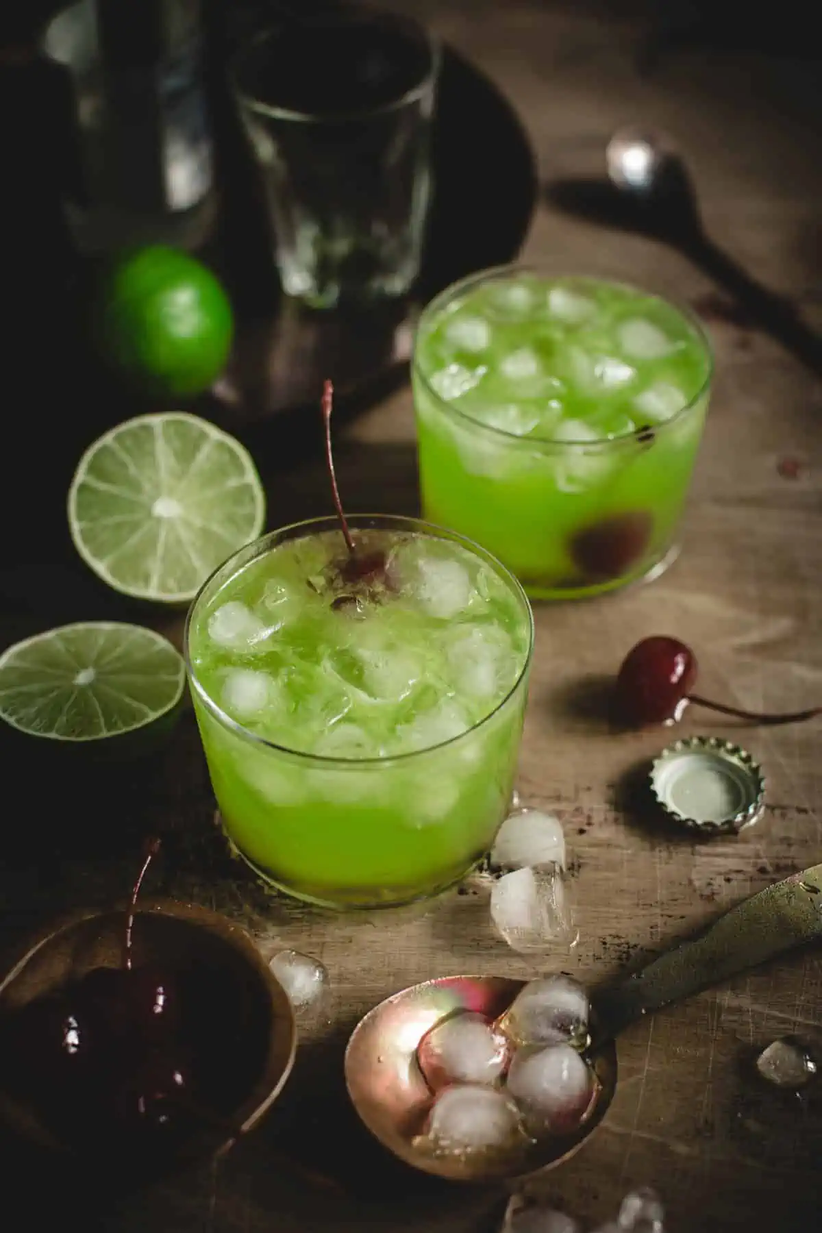 Midori Sour cocktails with cherry garnishes.