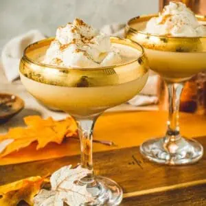 Pumpkin pie martini topped with whipped cream.